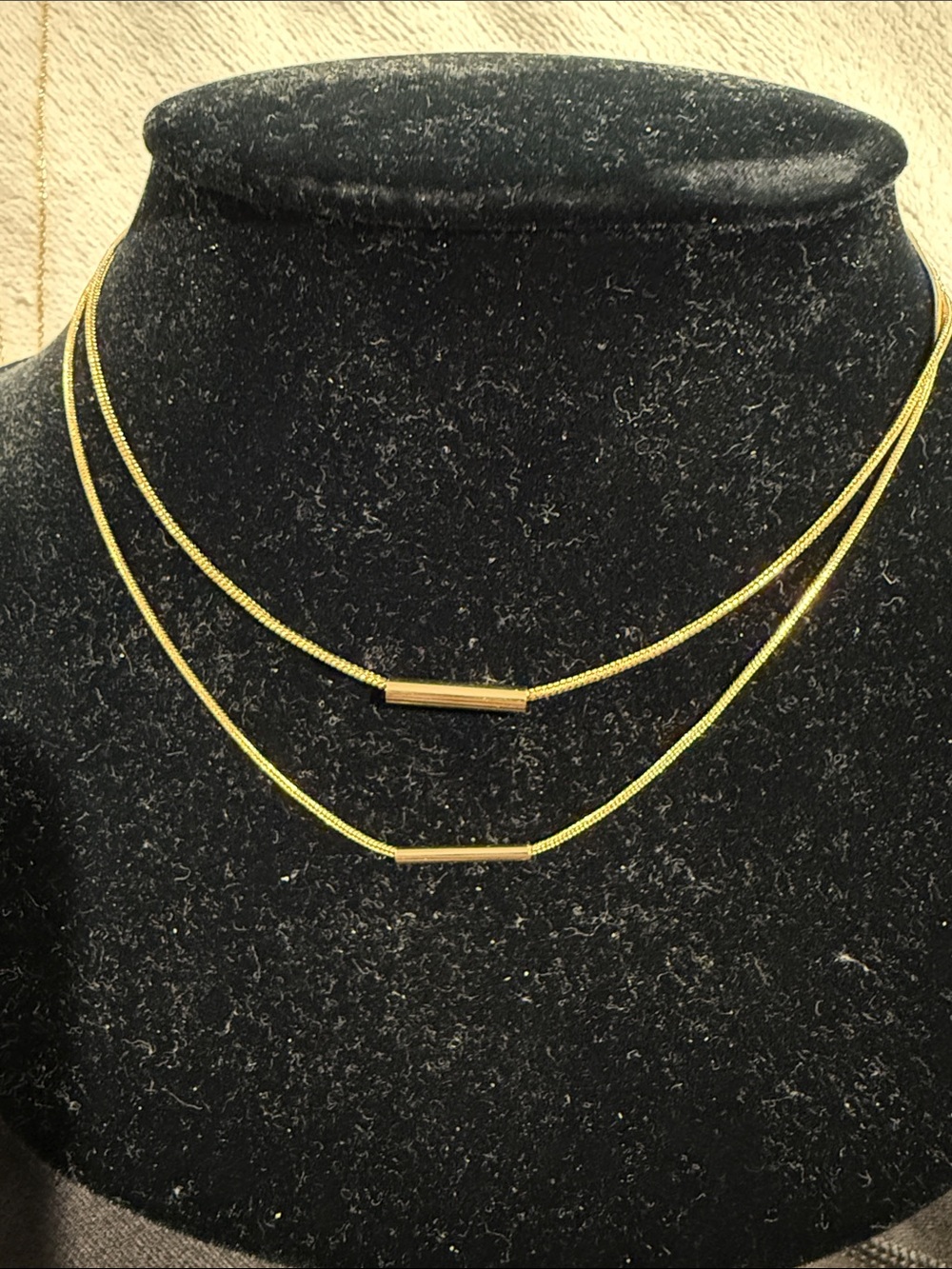 Double strand necklace with sliding bar
